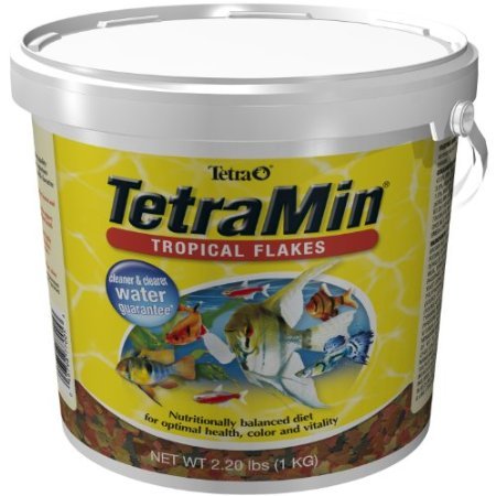 Tetramin tropical flakes closeup shows colorful flakes for clear water nutrition.