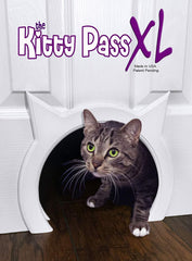 The Kitty Pass XL cat door on a door, semi-gloss white, for safe pet access.