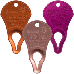 The Tick Key in action removing a tick from clothing during outdoor activity