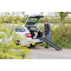 TRIXIE folded dog ramp stored compactly in car trunk.