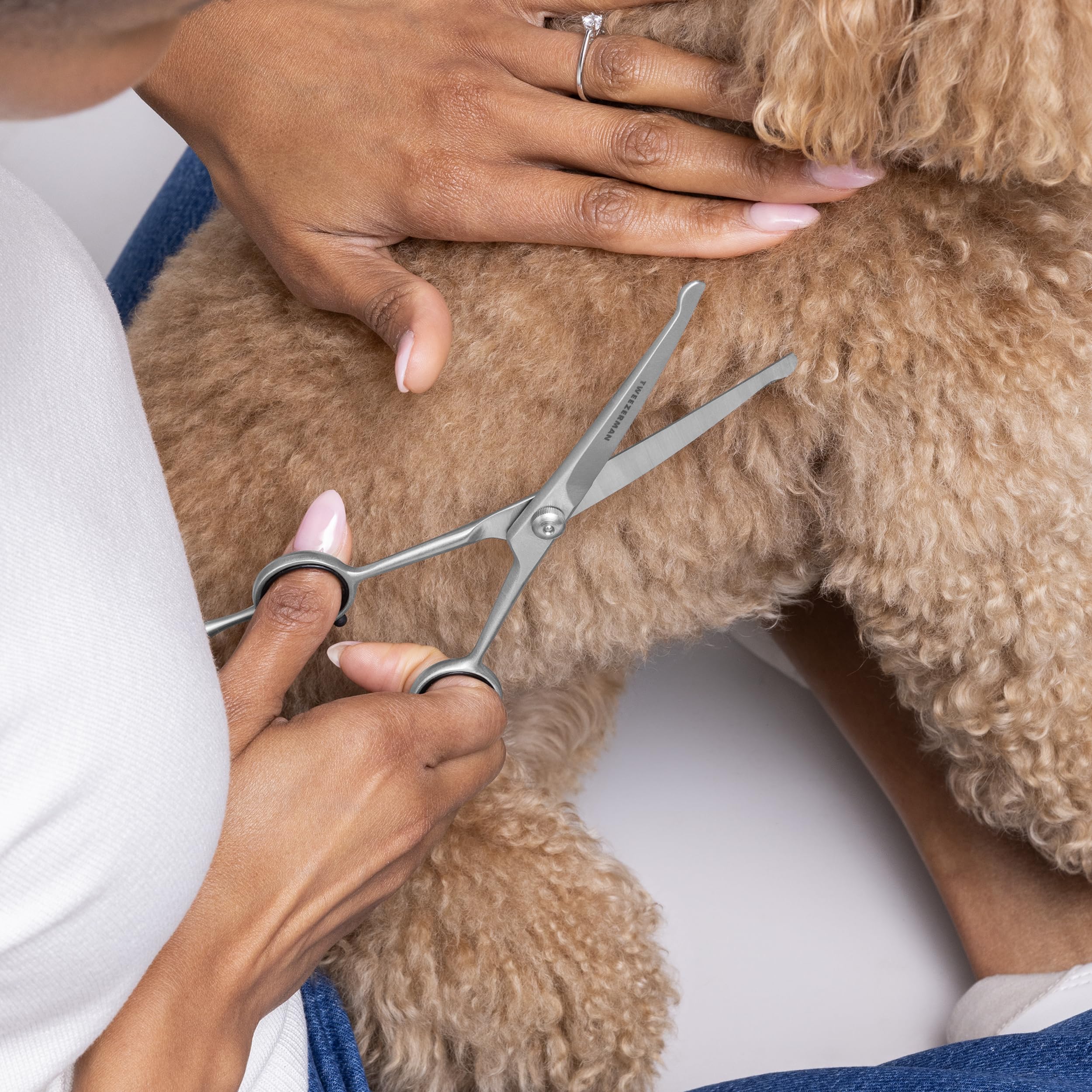 Tweezerman pet grooming scissors curved blades guide precise shaping of fur.