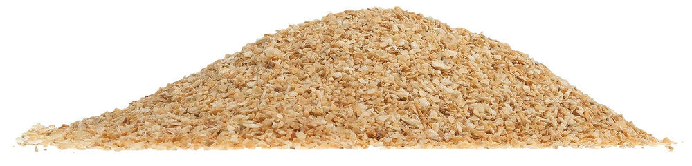 Garlic flakes being poured into horse feed from UltraCruz product.
