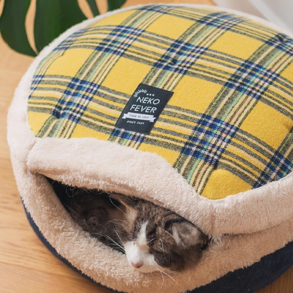 Urnat Cat Bed Cave in a living space, showcasing a compact, cozy fit.