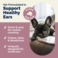Dog ear being cleaned with Oticbliss wipe during grooming.