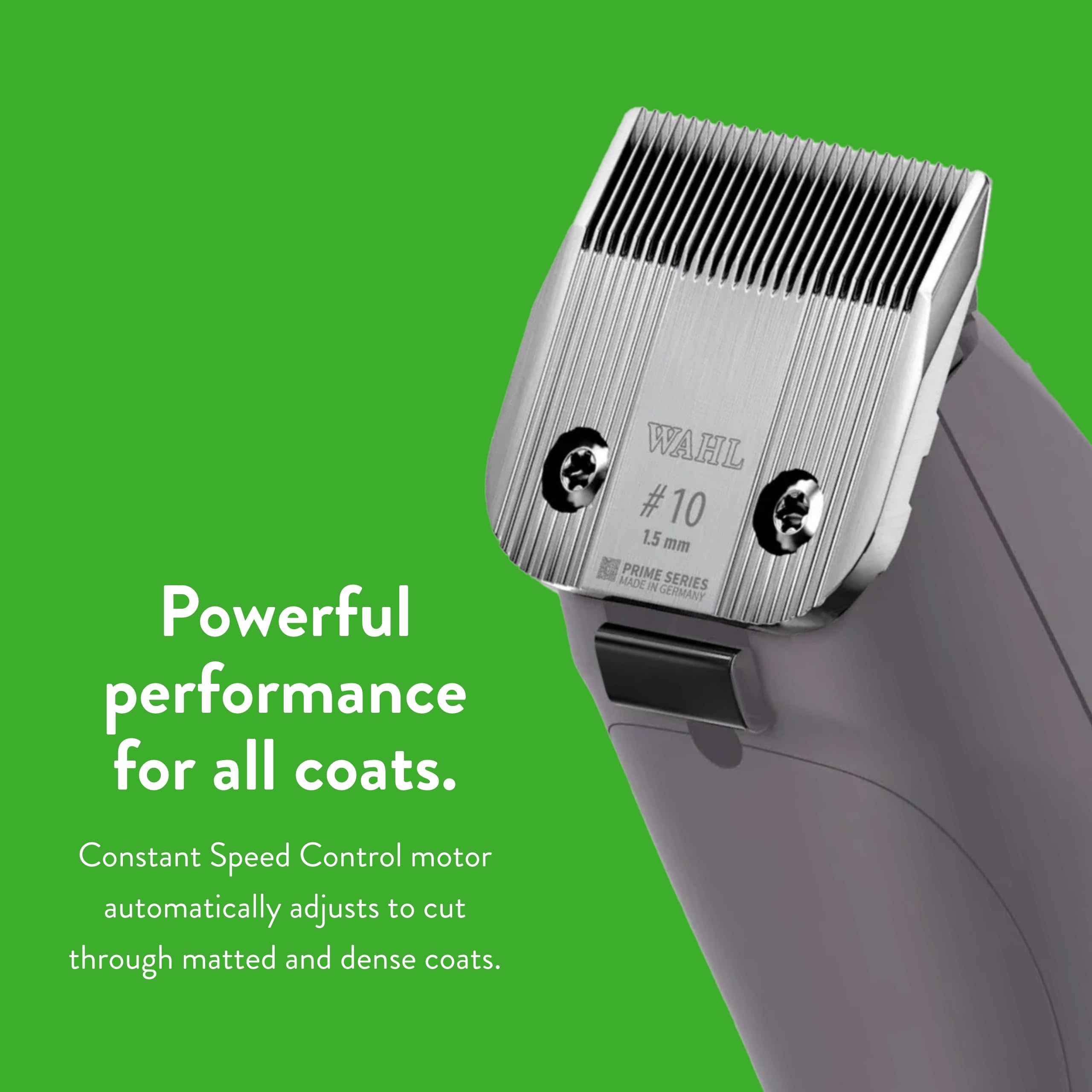 Groomer holds KM10+ with textured housing during cat grooming session.