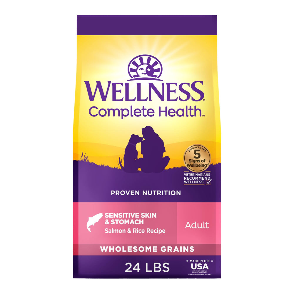 Wellness Complete Health dog food front packaging with salmon and rice for sensitive skin and stomach.