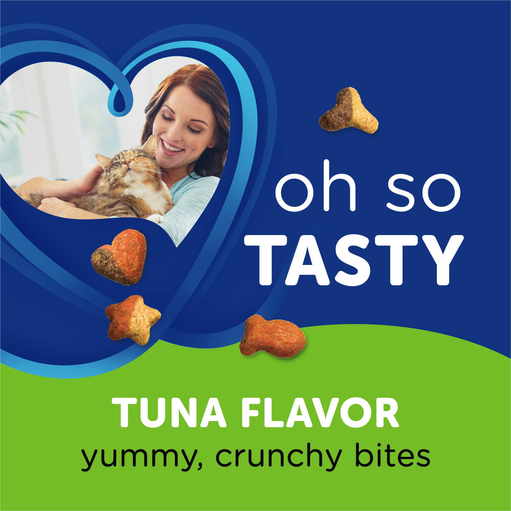 Cat paws reaching for Whisker Lickin's tuna treats during playtime.