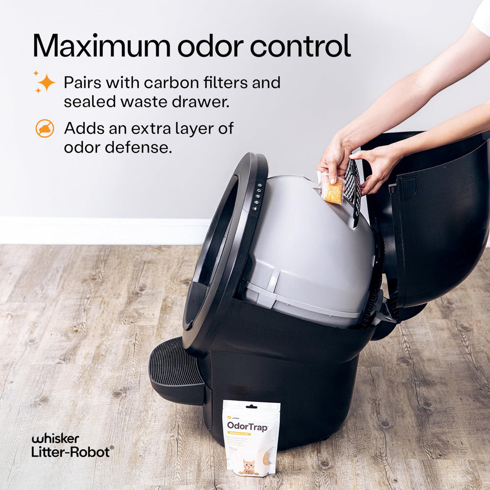 Whisker OdorTrap refill mounted near a traditional litter box for easy top-up