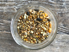 Wholesome Harvest All Flock Feed grain-blend close-up highlights non-GMO ingredients for natural nutrition.
