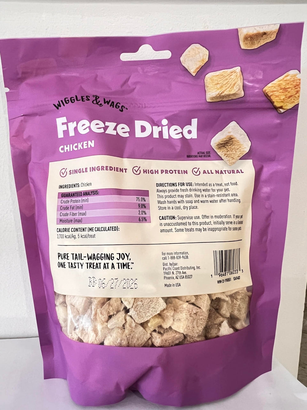 Close-up shows the crunchy texture of Wiggles & Wags freeze-dried chicken treats