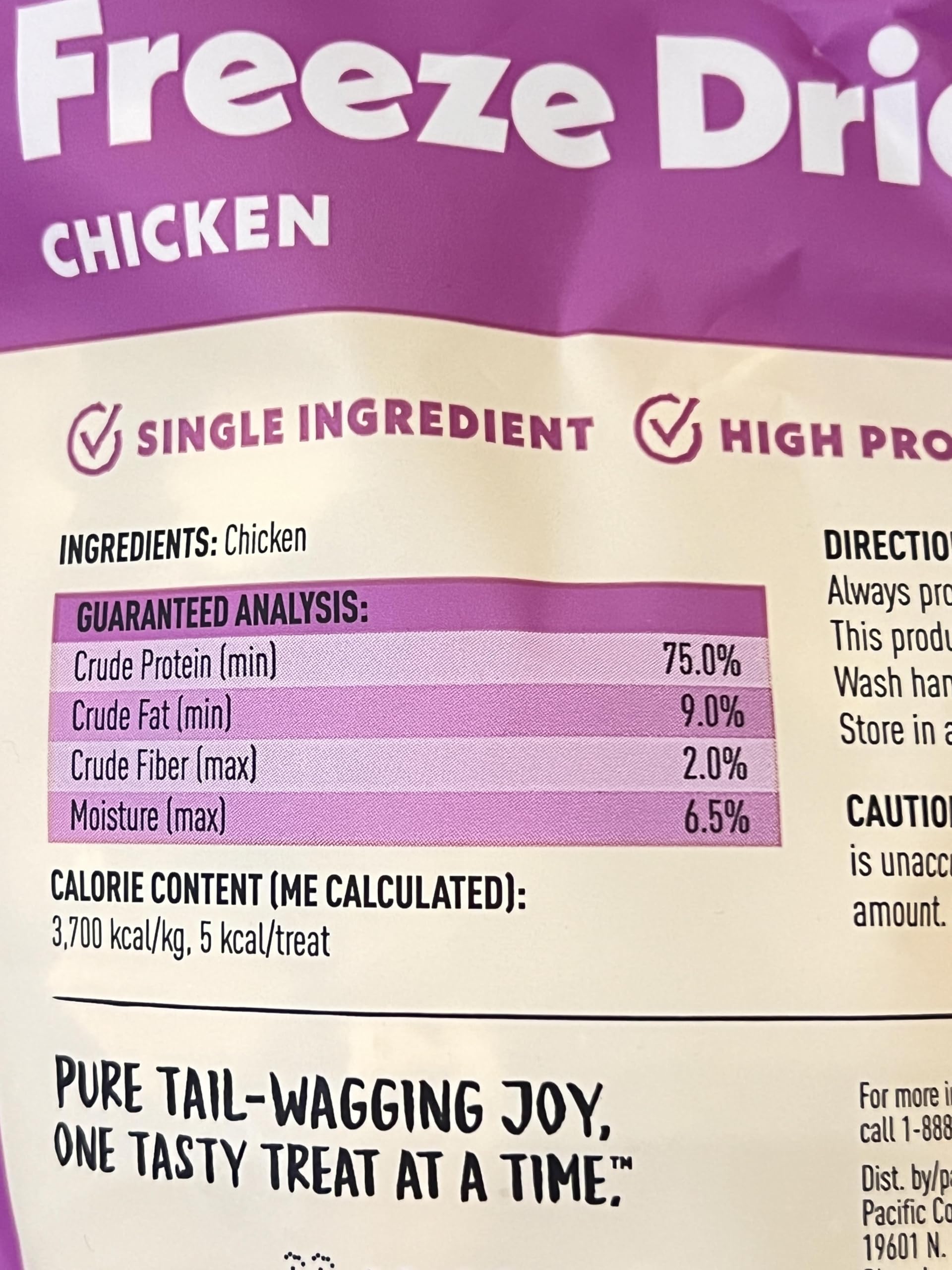 Dog enjoying Wiggles & Wags freeze-dried chicken treat during snack time
