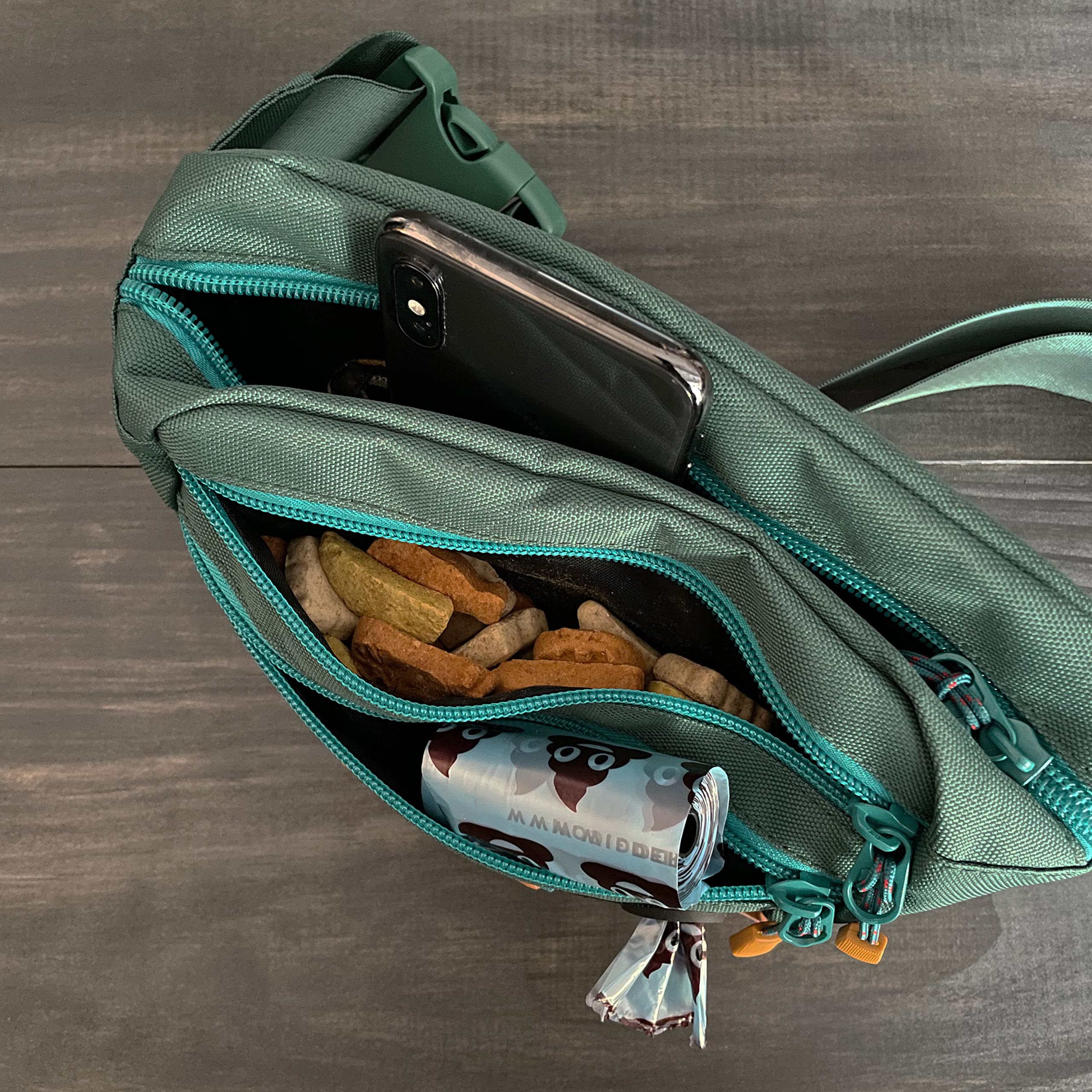 Wilderdog Utility Fanny Pack Evergreen dispenser image demonstrates built-in poop bag dispenser.