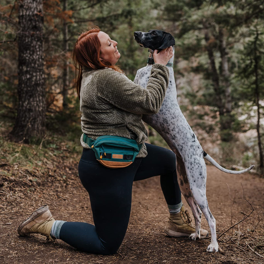 Wilderdog Utility Fanny Pack Evergreen strap-adjustment close-up highlights extended reach.