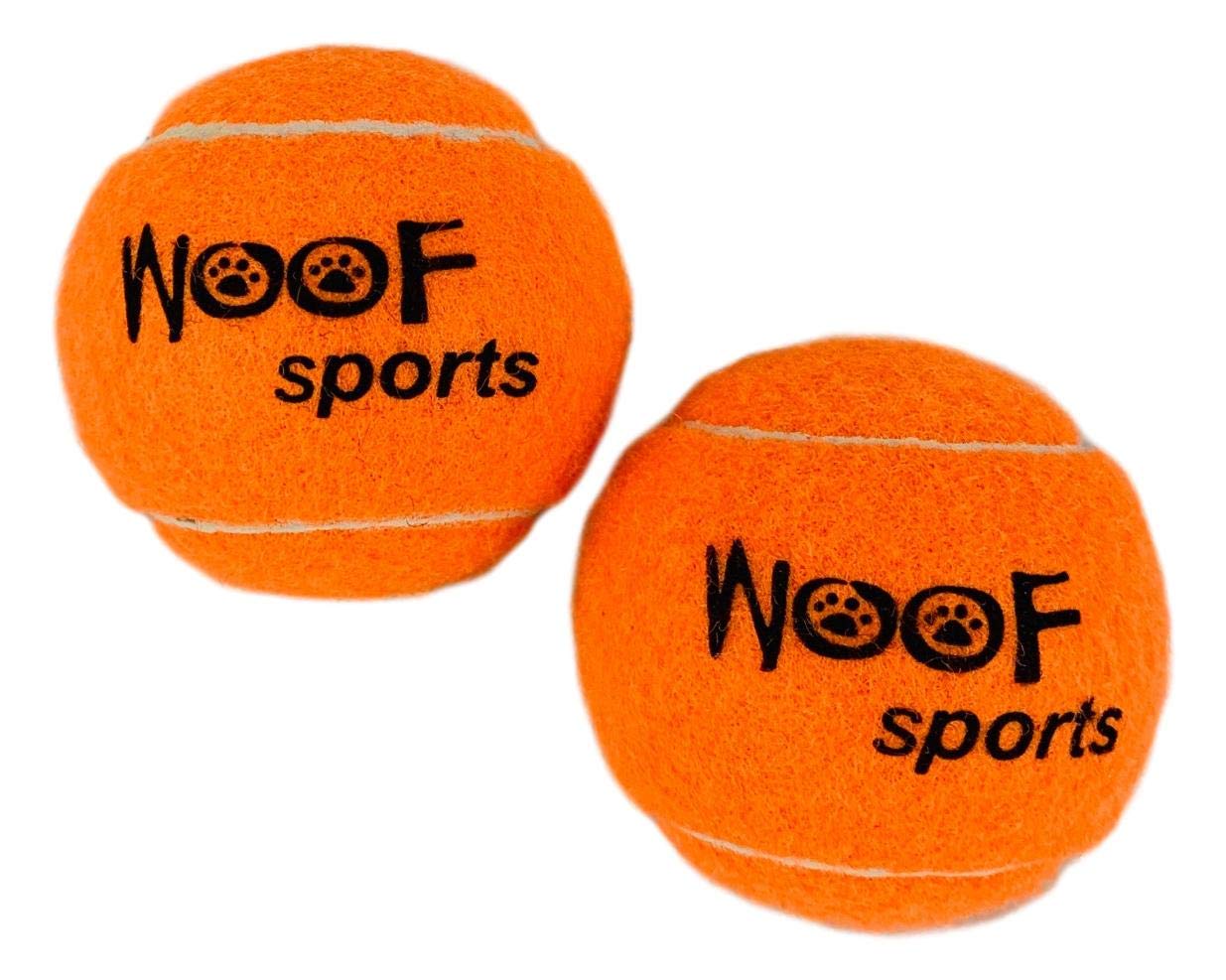 Woof Sports bright orange tennis balls visible in grass during play
