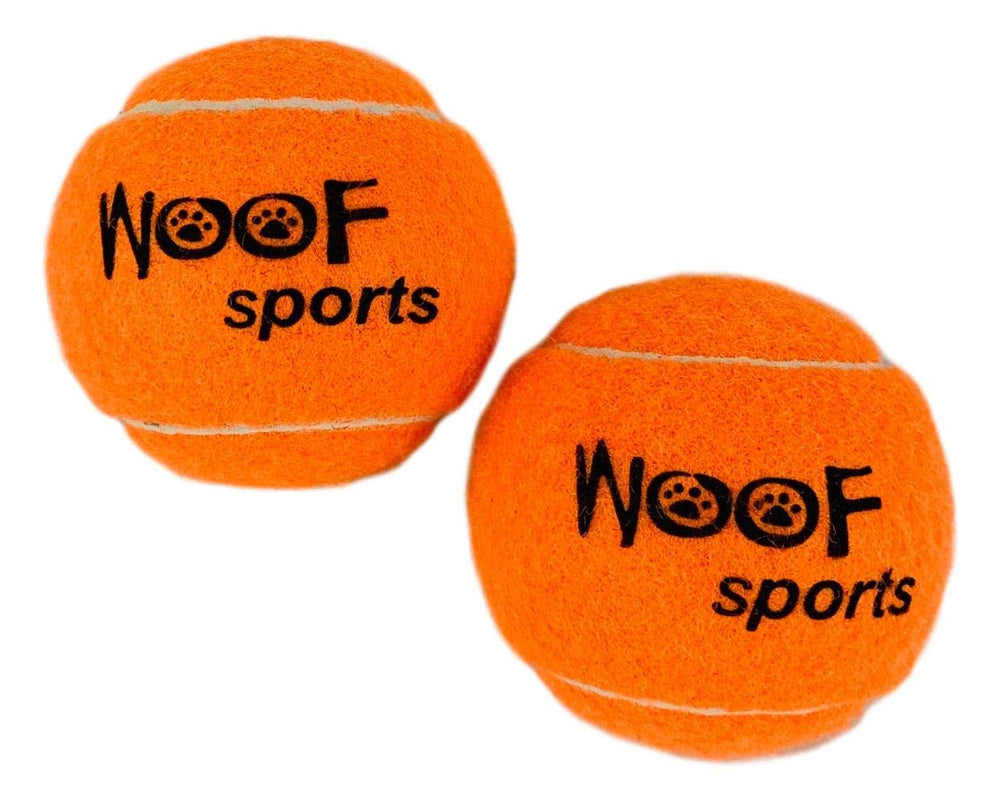 Woof Sports bright orange tennis balls visible in grass during play