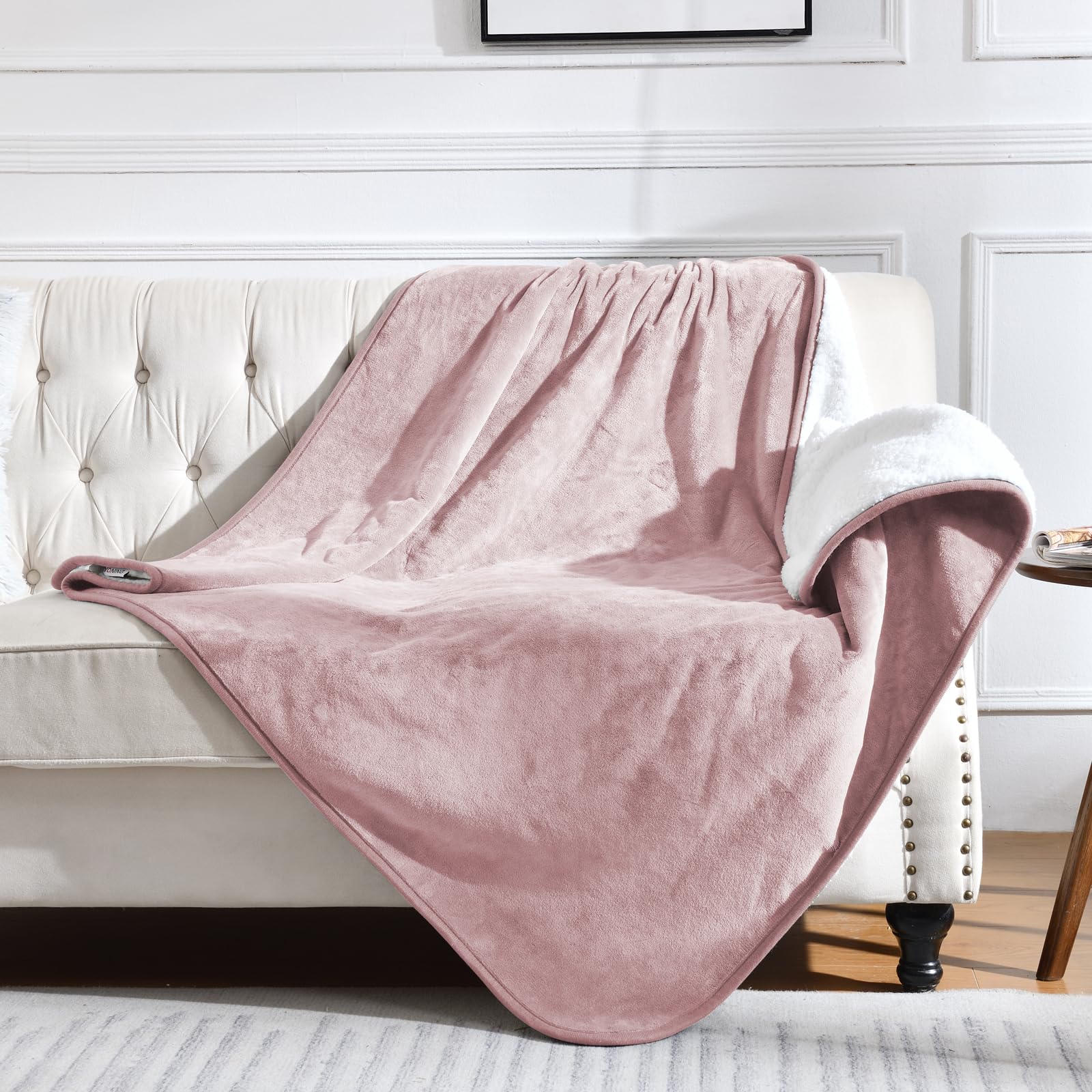 Yaning dusty pink waterproof blanket on bed provides leakproof protection for pets.