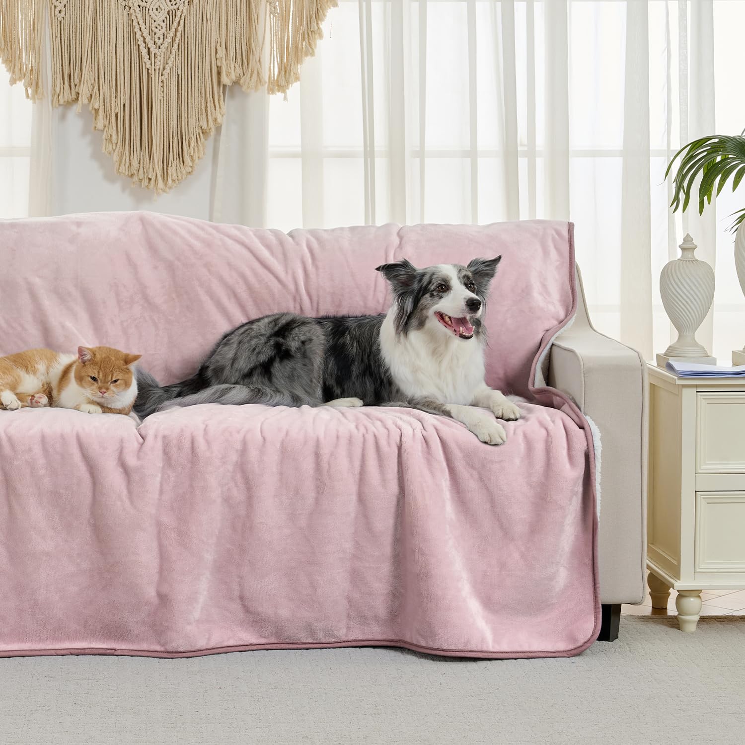 Yaning dusty pink waterproof blanket on sofa guards upholstery from spills and fur.