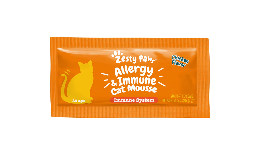 Zesty Paws user squeezes mousse over kibble for daily care.